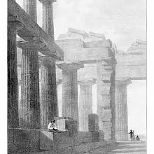 Doric colonnade of an ancient Greek temple at Paestum with an artist sitting on a stone