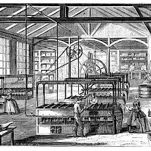 Workshop at the Cusinberche factory, where workers are busy around candle molding machines