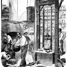 Contextual depiction of the stamping press at Christofle, showing workers busy around the machine