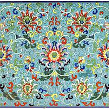 Floral pattern with meandering scrolls and volutes against a blue background