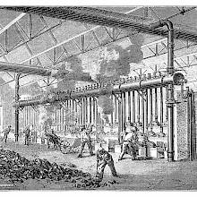 Workers are busy around furnaces in a workshop where the distillation of coal is taking place