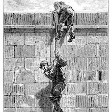 A man climbs down a rope from the top of a wall, followed by his companion