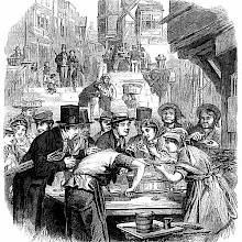 People are gathered around the stall of an oyster seller
