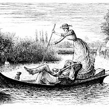 A man reclining on a small river boat plays the banjo as a woman pushs on the oar behind him