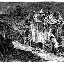 A handful of men are seen pushing a crowded stagecoach with passengers sitting on the roof.