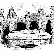 A shrouded mummy lies on a stone bed