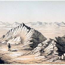 The Great Salt Lake, Utah, with jagged rocks in the foreground and a hilly island in the distance