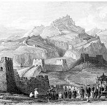 A column of travelers populates a sweeping landscape of mountains, across which the Great Wall of China meanders