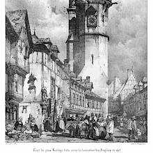 View of a busy street showing timber-framed medieval houses with corbeled windows and the Évreux clock tower
