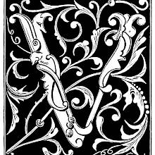 Capital V decorated with foliage motifs and scrolls on a black background