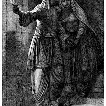 A man holds a woman by the hand and lights the way as they walk down a flight of stairs