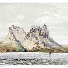 A circular group of mountains with jagged summits slopes down toward the Norwegian Sea