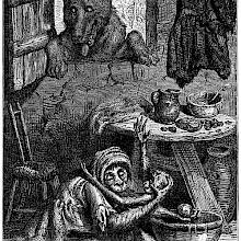 A female monkey sits on the floor of a modest home, craddliong a young one in her arms