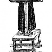 A man is shown standing at a pillory