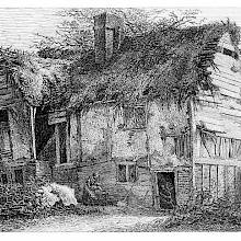 View of a picturesque and weather-worn cottage with a dilapidated thatched roof