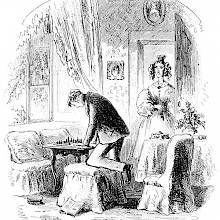 A man with one knee resting on a pouffe leans over a chessboard as a woman enters the room