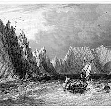 A small sailboat approaches Scratchell's Bay with the Needles Rocks on the left