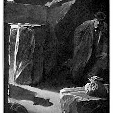 A man crouches at the bottom of a hut as the shadow of a man approaching can be seen on the ground