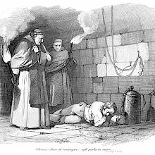 A prisoner chained to a post lies asleep on a cell floor, watched by two monks carrying torches