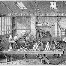 View of a workshop where food is canned and the cans are soldered before being taken away