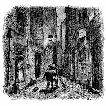 Two men are fighting in a narrow street at night