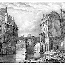 View of an arched bridge stretching over a stream with half-timbered houses on each side