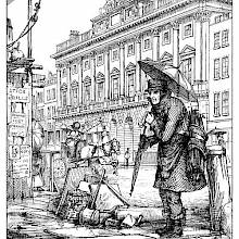 A man stands in the rain with an umbrella over his head and a bunch of them strapped to his back