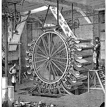 View of a wallpaper printing machine shaped like a large wheel and equipped with color troughs