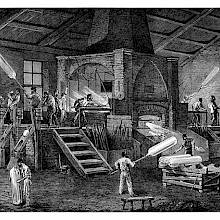 Interior of a cylinder glass factory with workers busy blowing cylinders around a furnace