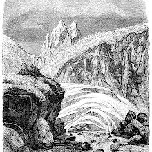 Alpine landscape with rocks, ice sheets, a jagged glacier, and spiky mountain peaks