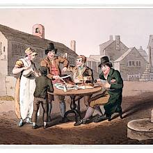 A host and hostess stand next to a table set up in the street and treat their two guests