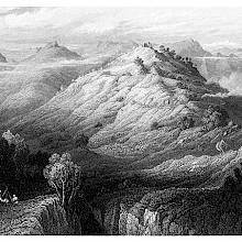 Bird's eye view of a mountainous landscape with a cone-shaped hill standing at its center