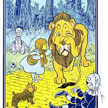 A young girl admonishes a sheepish lion which has been throwing around her companions