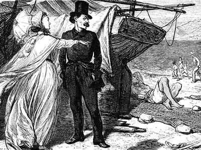 A woman points her finger while having a conversation with a man near a boat sitting on the sand