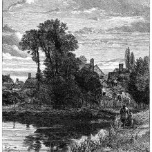 View of a large pond with a village behind it, partly hidden by a clump of trees