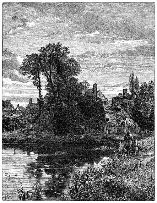 View of a large pond with a village behind it, partly hidden by a clump of trees