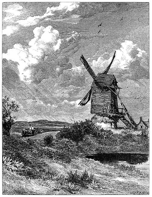 View of a windmill standing in the open countryside with a pond in the foreground