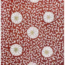 Intricate design with white flowers against a reddish brown background