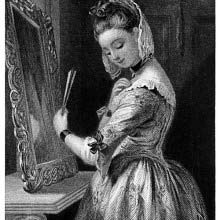 A young woman stands before a mirror and straightens the collar of her dress