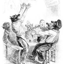 One human sits with five wolves at a table outside a restaurant