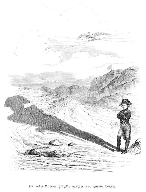 Napoleon stands in a desert where the sun projects his shadow far in front of him