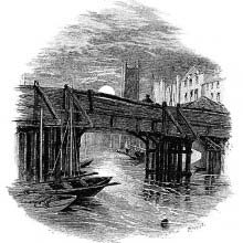 A wooden bridge is seen from a low angle with the moon and a tower in the background