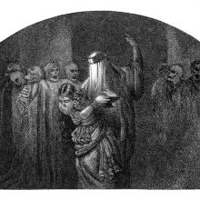 A woman is led by a veiled figure through a place with bodies tied to pillars