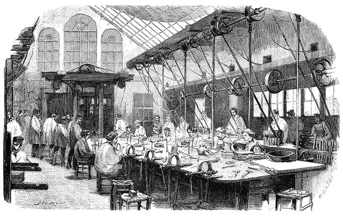 Silversmith's workshop where workers can be seen at a large collective workbench