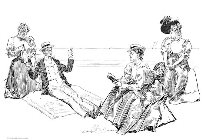 A man is lounging on a beach in the company of fairly indifferent women