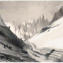 Glacier surrounded by two slopes with jagged rocky peaks in the background