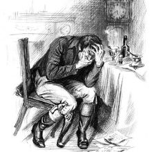 A grimacing man tormented by toothache sits at his desk holding his jaw