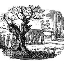 A tree in the foreground partly hides a funeral procession arriving at the church