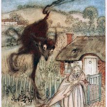 A strange large furry animal suddenly appears behind a smiling woman standing at a gate