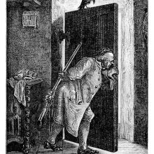 A man who stands behind a door while keeping it ajar hides a gun behind his back